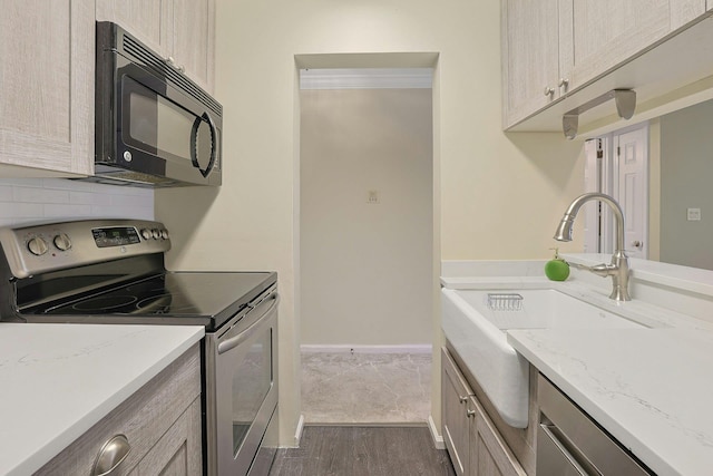 500 Pondside Dr Unit 2E, White Plains, NY 10607 - kitchen featuring black microwave, stainless steel electric range, dark wood-style flooring, a sink, and light stone countertops