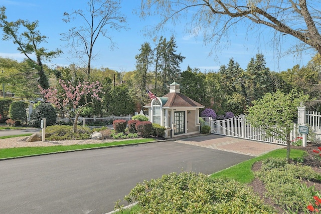 500 Pondside Dr Unit 2E, White Plains, NY 10607 - view of asphalt street featuring a gate, curbs, and a gated entry