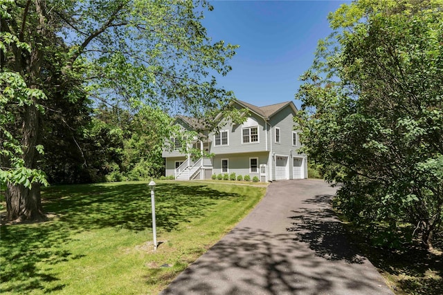19 Old Bulls Head Rd, Rhinebeck, NY 12572 - view of front of house with driveway, an attached garage, stairway, and a front lawn