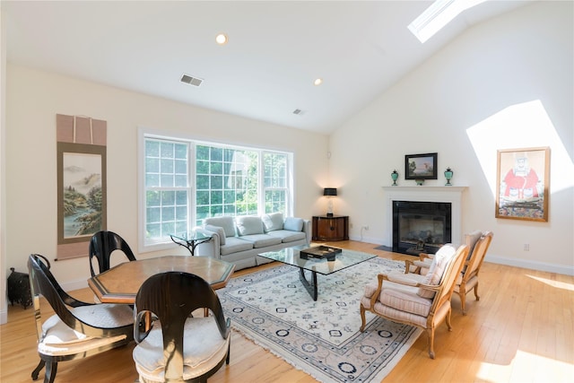 19 Old Bulls Head Rd, Rhinebeck, NY 12572 - living area with a skylight, light wood-type flooring, a fireplace with flush hearth, baseboards, and high vaulted ceiling