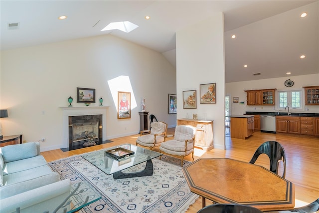 19 Old Bulls Head Rd, Rhinebeck, NY 12572 - living room featuring a skylight, a fireplace with flush hearth, light wood-type flooring, recessed lighting, and baseboards