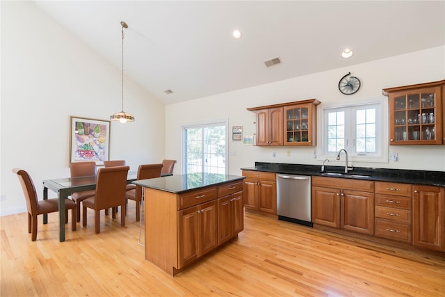 19 Old Bulls Head Rd, Rhinebeck, NY 12572 - kitchen with stainless steel dishwasher, a sink, brown cabinetry, light wood-type flooring, and plenty of natural light