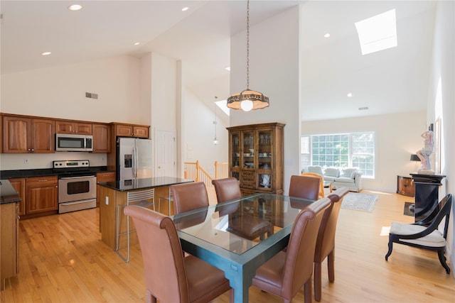 19 Old Bulls Head Rd, Rhinebeck, NY 12572 - dining room with a skylight, high vaulted ceiling, light wood-style floors, and recessed lighting