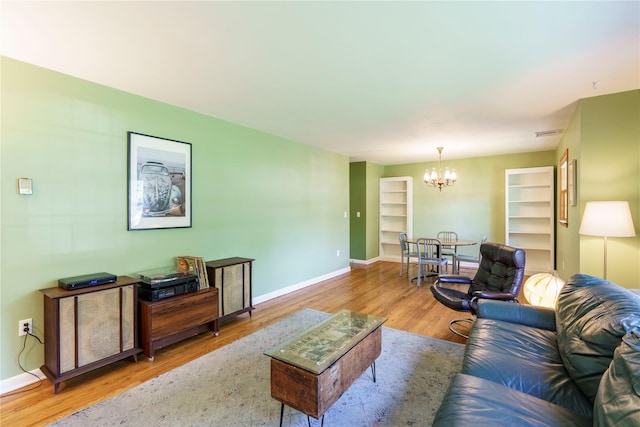 49 Lorraine Dr, Rhinebeck, NY 12572 - living area with a chandelier, wood finished floors, and baseboards