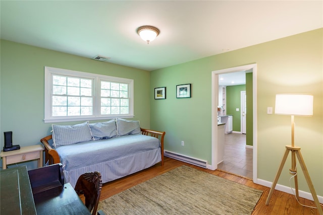 49 Lorraine Dr, Rhinebeck, NY 12572 - bedroom featuring a baseboard radiator, wood finished floors, and baseboards