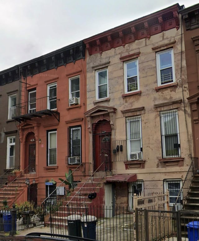 1022 Greene Ave, Brooklyn, NY 11221 - multi unit property with stairs, a fenced front yard, and cooling unit