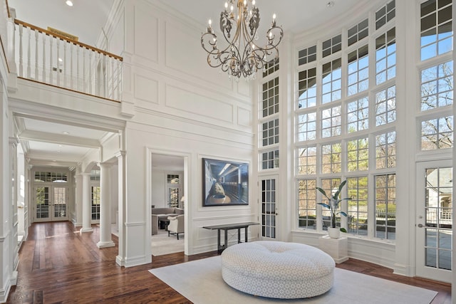 24 Penwood Rd, Bedford Corners, NY 10549 - sitting room with decorative columns, a towering ceiling, dark wood-style flooring, and ornamental molding
