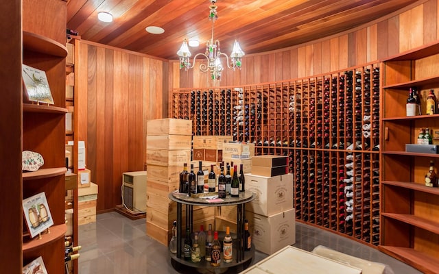 24 Penwood Rd, Bedford Corners, NY 10549 - wine area with wood ceiling, wood walls, and a notable chandelier