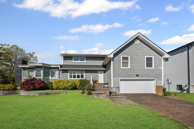 view of front of home featuring aphalt driveway, a garage, and a front lawn