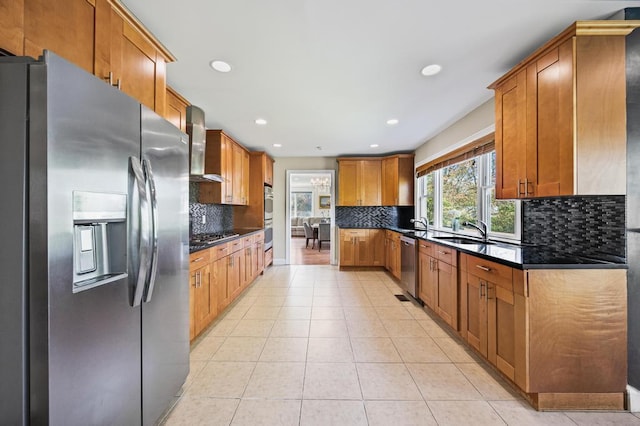 kitchen featuring recessed lighting, appliances with stainless steel finishes, tasteful backsplash, and wall chimney exhaust hood
