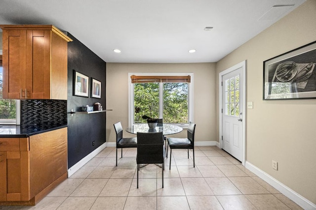 dining room with baseboards, light tile patterned floors, and recessed lighting