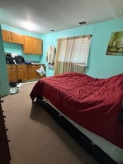 bedroom featuring visible vents and carpet