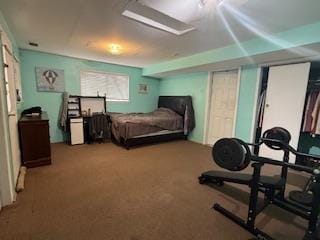 bedroom featuring multiple closets and carpet flooring