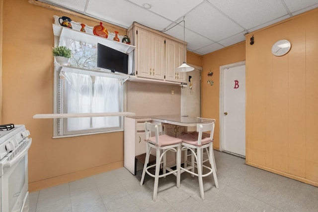 kitchen featuring a paneled ceiling and white gas range