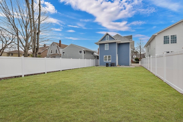 view of yard with a fenced backyard and a residential view