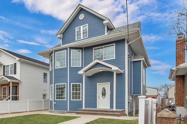 american foursquare style home featuring fence