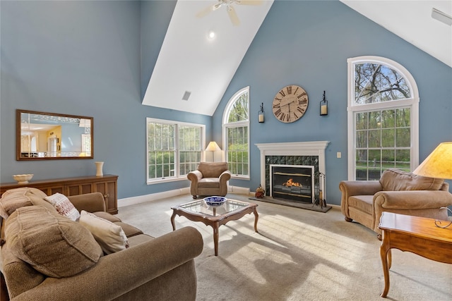 carpeted living area featuring baseboards, a ceiling fan, a fireplace, and high vaulted ceiling