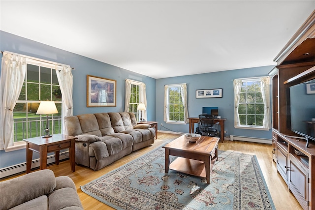 living room featuring a baseboard heating unit and light wood-style floors