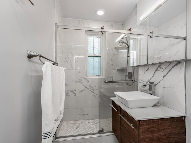 bathroom featuring vanity, tasteful backsplash, and a marble finish shower