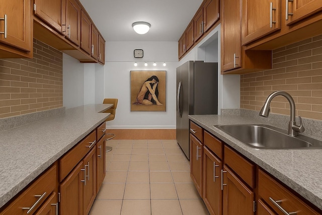 2630 Kingsbridge Ter Unit 2St, Bronx, NY 10463 - kitchen featuring a sink, freestanding refrigerator, decorative backsplash, light tile patterned floors, and brown cabinets