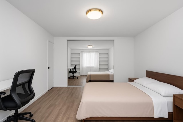 2630 Kingsbridge Ter Unit 2St, Bronx, NY 10463 - bedroom featuring light wood finished floors, a desk, a closet, and baseboards