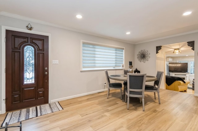 dining area featuring light wood-type flooring, ornamental molding, baseboards, and recessed lighting