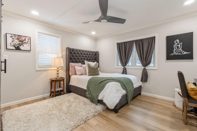 bedroom with crown molding, baseboards, wood finished floors, a ceiling fan, and recessed lighting