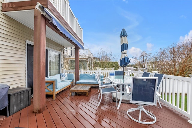 wooden deck with outdoor dining area and an outdoor living space