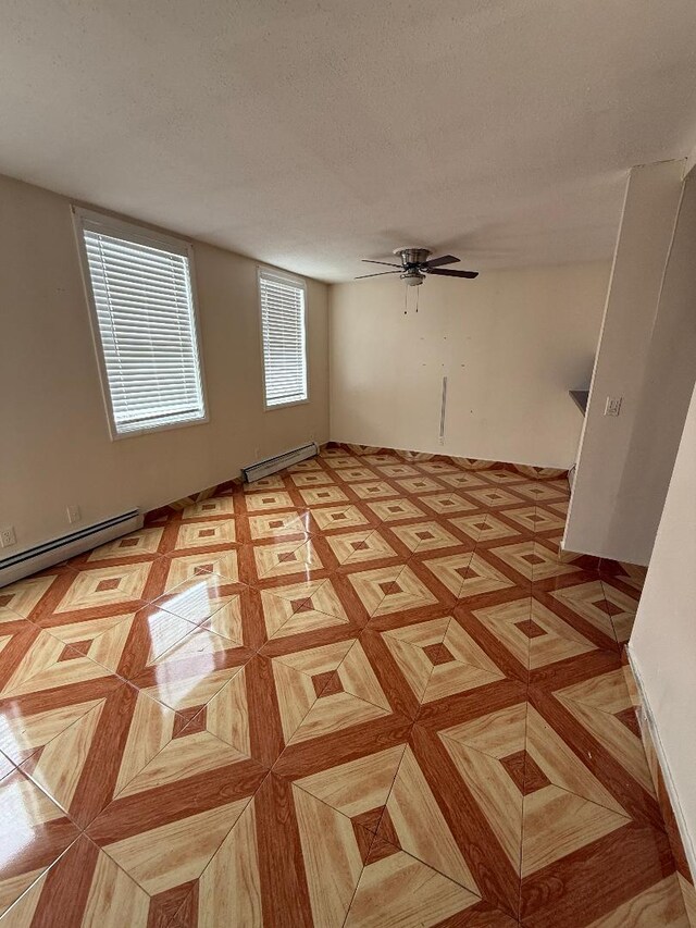 1170 Vyse Ave, Bronx, NY 10459 - empty room featuring a baseboard radiator, ceiling fan, and a textured ceiling