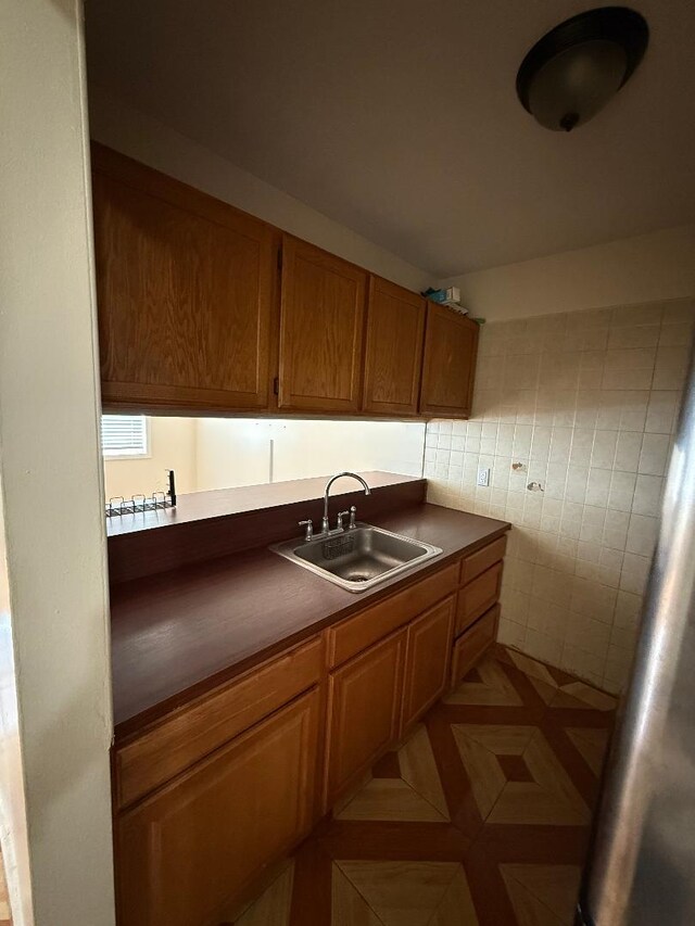 1170 Vyse Ave, Bronx, NY 10459 - kitchen featuring dark countertops and brown cabinets