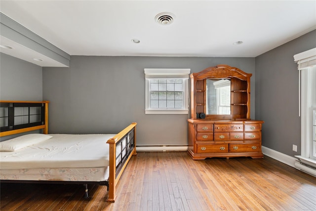 249 Cherry Ln, Airmont, NY 10901 - bedroom with baseboard heating, hardwood / wood-style flooring, and baseboards