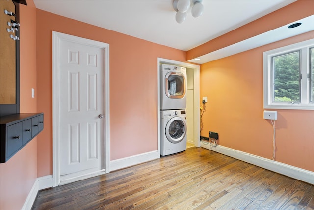 249 Cherry Ln, Airmont, NY 10901 - washroom featuring estacked washer and dryer, wood finished floors, and baseboards