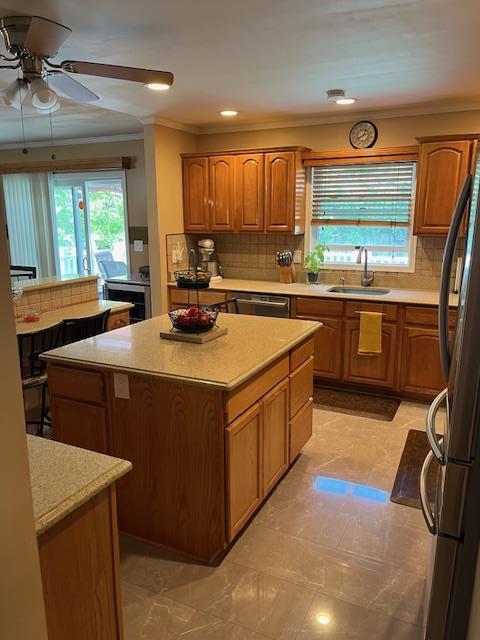 2659 Rte 52, Hopewell Junction, NY 12533 - kitchen with a healthy amount of sunlight, a center island, a sink, ceiling fan, and brown cabinets