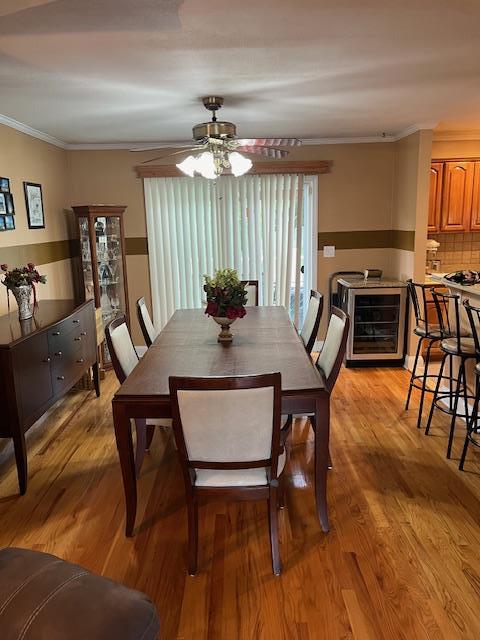2659 Rte 52, Hopewell Junction, NY 12533 - dining space with ceiling fan, light wood-style flooring, wine cooler, and crown molding