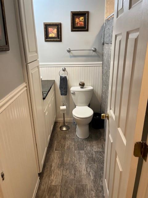 2659 Rte 52, Hopewell Junction, NY 12533 - full bath with wainscoting, wood finished floors, toilet, and curtained shower