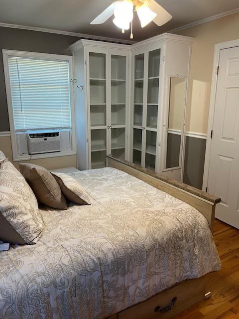 2659 Rte 52, Hopewell Junction, NY 12533 - bedroom with ornamental molding, cooling unit, a ceiling fan, and wood finished floors