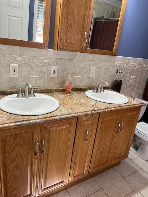 2659 Rte 52, Hopewell Junction, NY 12533 - full bathroom featuring tile patterned flooring, a sink, toilet, and double vanity