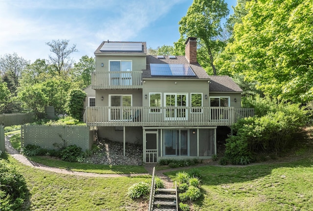 2716 Salt Point Tpke, Clinton Corners, NY 12514 - rear view of property featuring solar panels, a chimney, a wooden deck, a sunroom, and roof with shingles