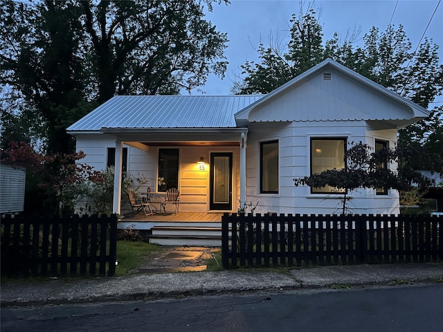 55 Upper Main St, Callicoon, NY 12723 - view of front of home with a porch, a fenced front yard, and metal roof