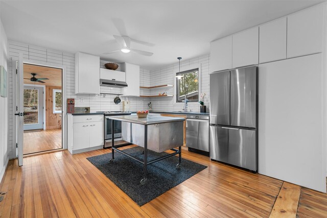 55 Upper Main St, Callicoon, NY 12723 - kitchen featuring stainless steel appliances, ceiling fan, under cabinet range hood, and white cabinetry