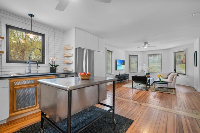 55 Upper Main St, Callicoon, NY 12723 - kitchen with ceiling fan, dark countertops, light wood-type flooring, and freestanding refrigerator
