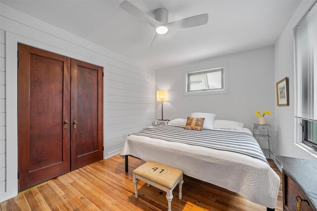 55 Upper Main St, Callicoon, NY 12723 - bedroom featuring light wood-style flooring, wooden walls, and a ceiling fan
