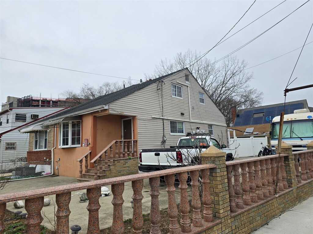 view of front facade featuring stucco siding and fence