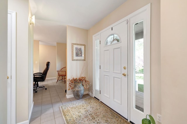 foyer featuring baseboards and light tile patterned floors