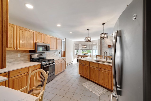 kitchen featuring a baseboard radiator, light tile patterned floors, a sink, appliances with stainless steel finishes, and backsplash