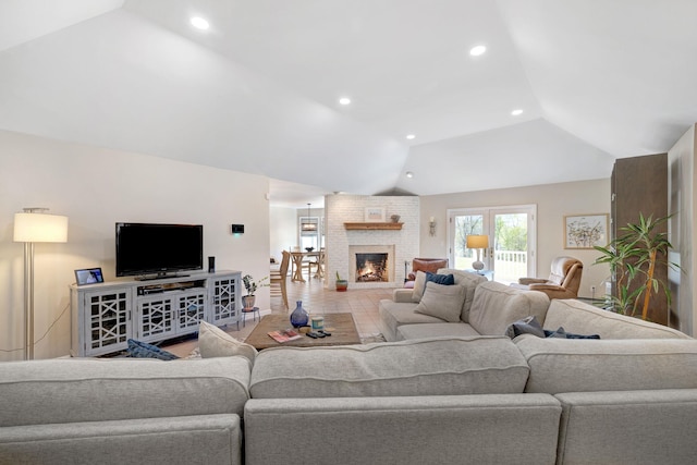 living area featuring a healthy amount of sunlight, a brick fireplace, recessed lighting, and lofted ceiling