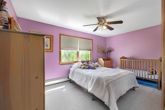 bedroom with a ceiling fan, carpet, and a baseboard heating unit