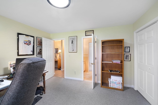 home office featuring baseboards and carpet