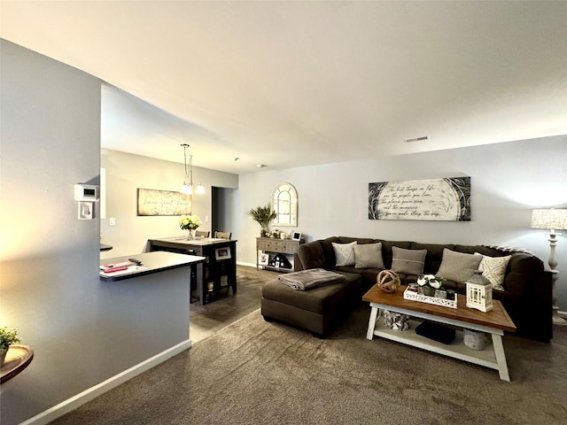 23 Kiowa Ct Unit 23, Coram, NY 11727 - living room featuring baseboards, dark colored carpet, and visible vents