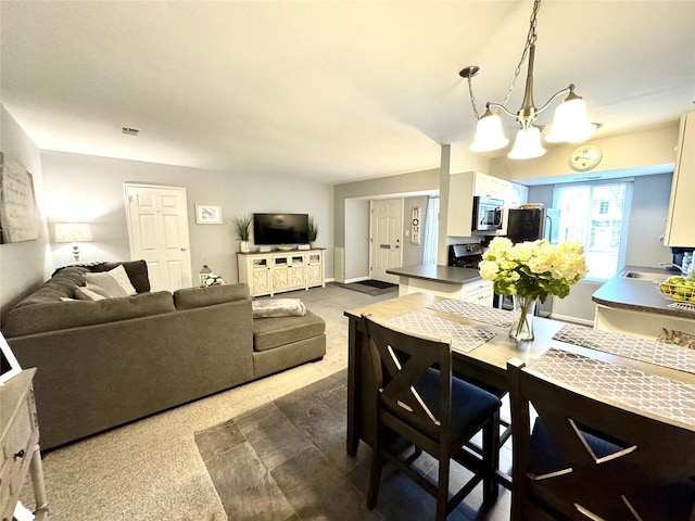 23 Kiowa Ct Unit 23, Coram, NY 11727 - dining area with baseboards, a chandelier, and visible vents